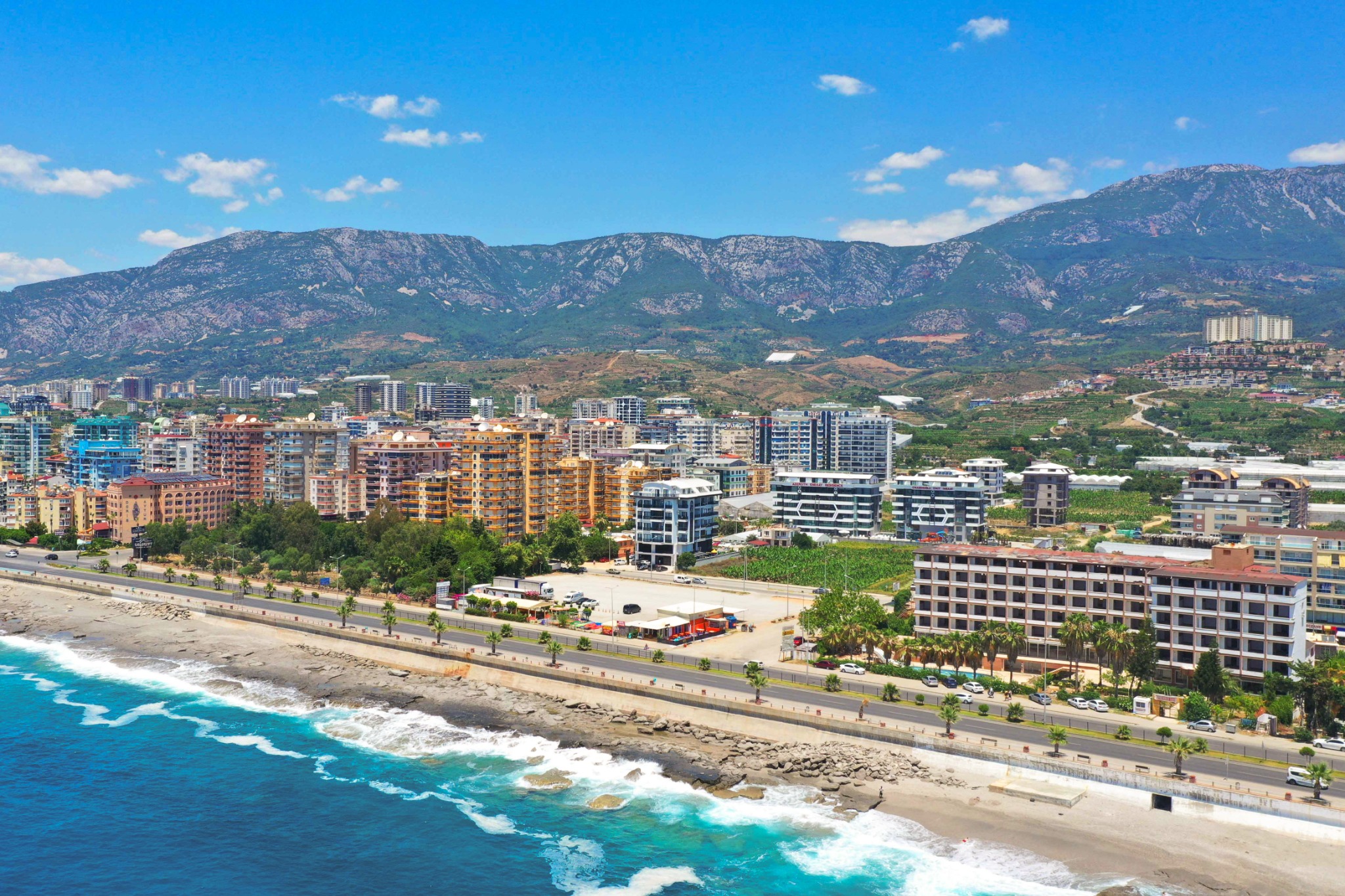 Aerial view of Alanya beachfront city skyline and Taurus Mountains