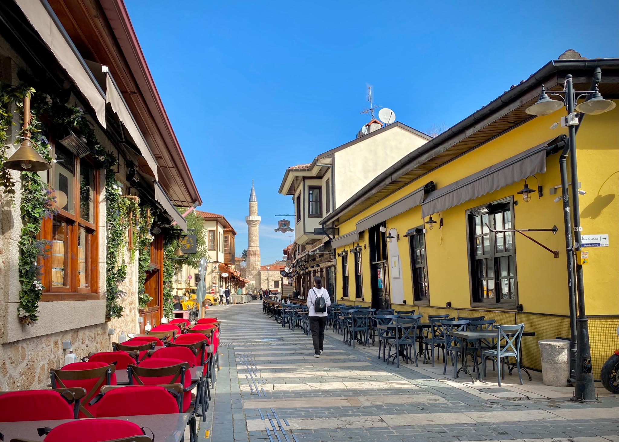 Cafe-lined street in Kaleici old town Antalya with a mosque minaret