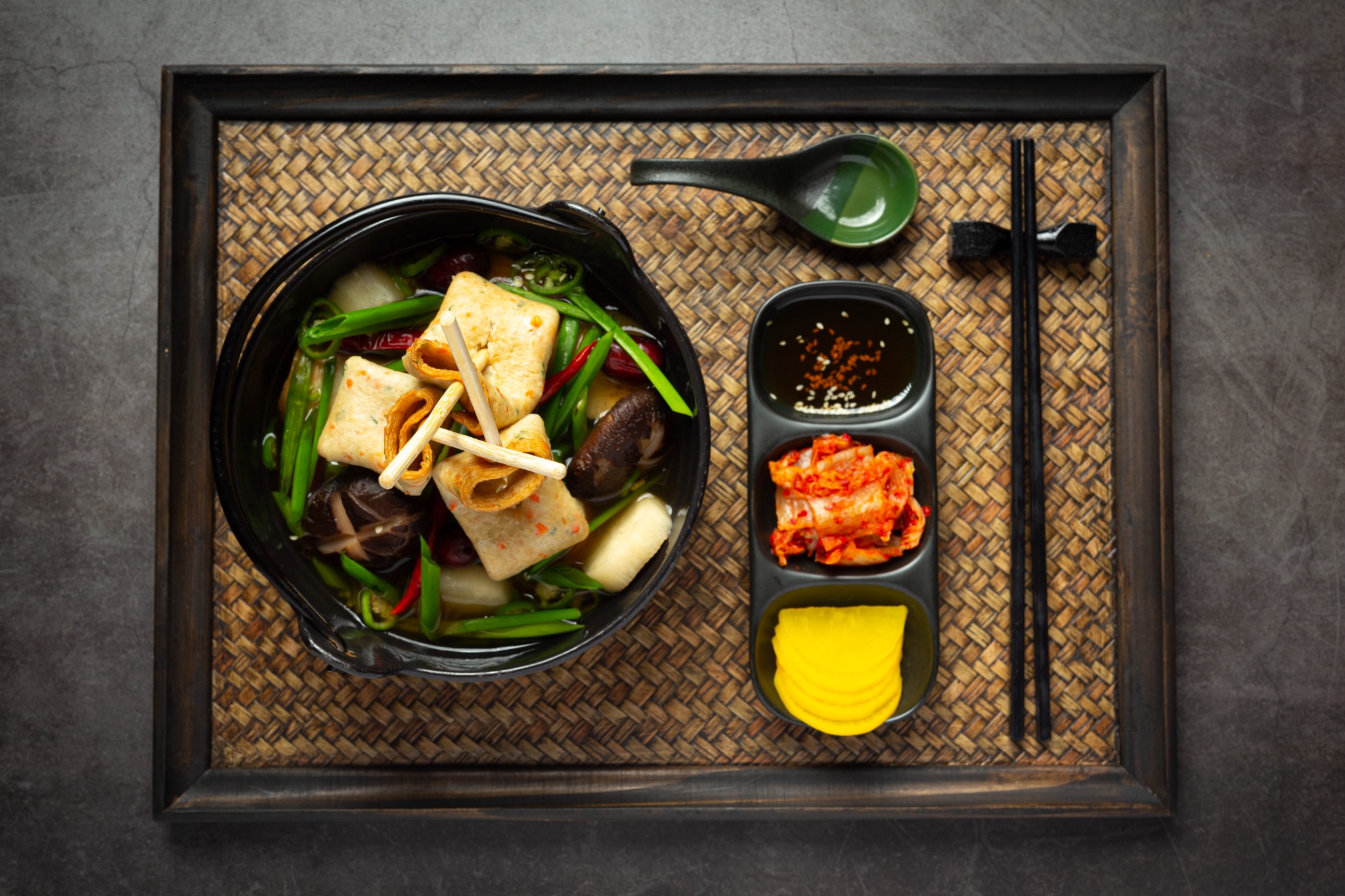 Korean fish cake and vegetable soup served with kimchi and pickled radish.