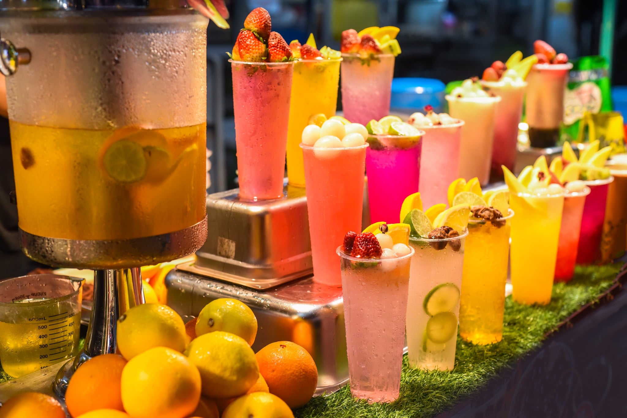 Colorful tropical fruit drinks and smoothies are displayed at a Jalan Alor street stall in Kuala Lumpur.
