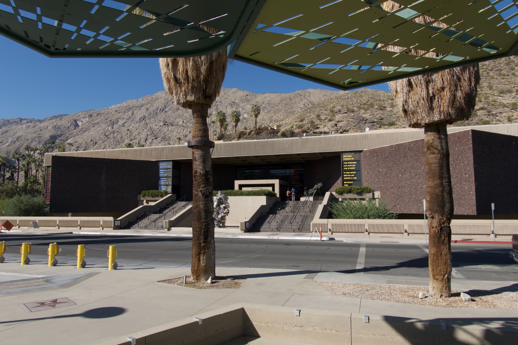 Palm Springs Art Museum entrance with palm trees and San Jacinto Mountains