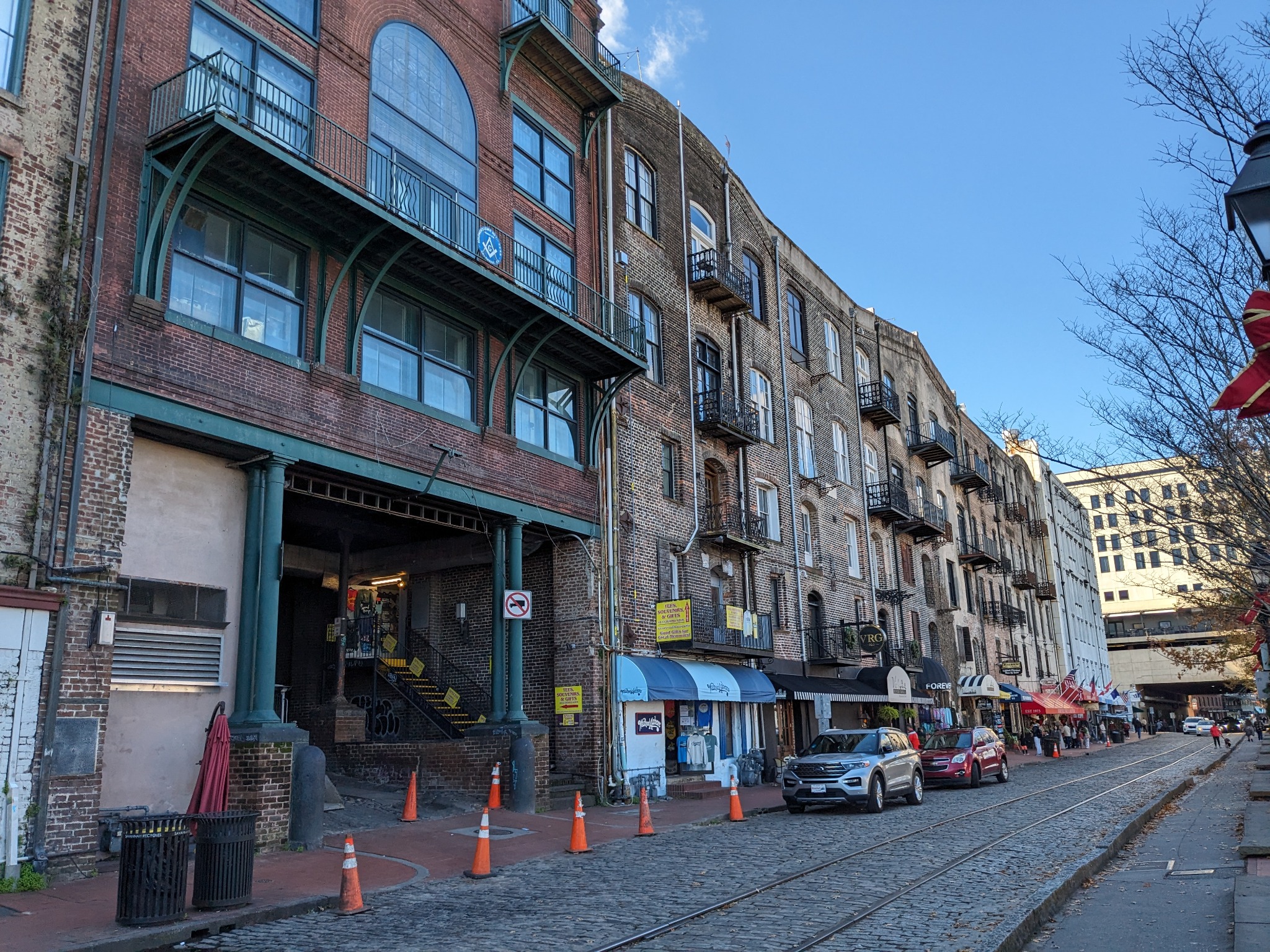 Historic warehouse façades, balconies and cobblestone tracks define Savannah's River Street district.