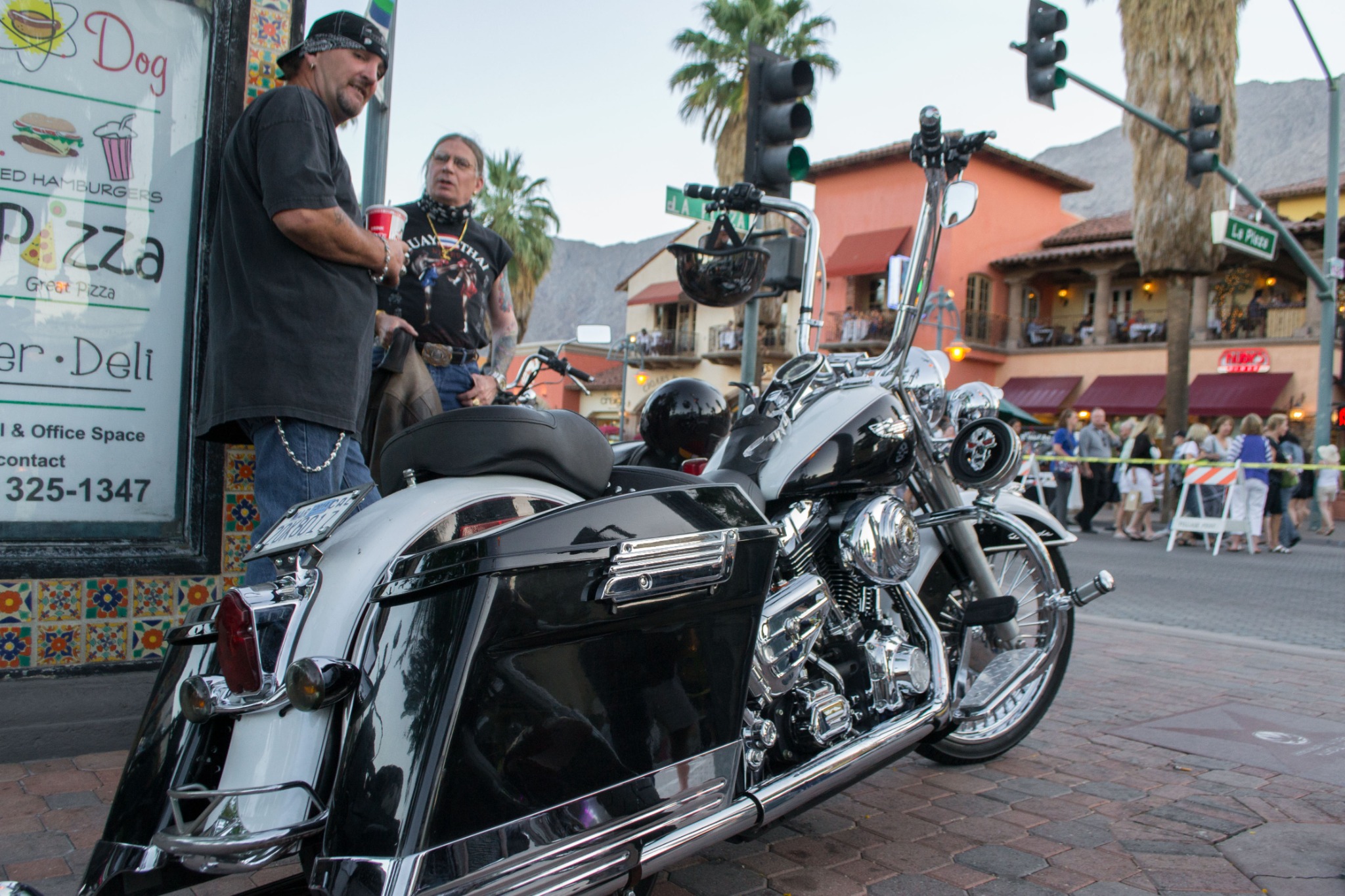 Touring motorcycle and visitors during VillageFest on Palm Canyon Drive in Palm Springs